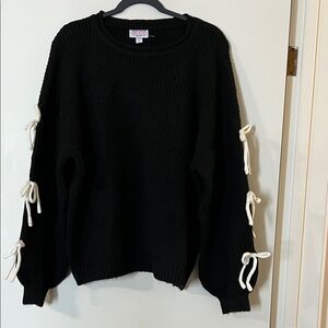 Elegant Black Sweater with White Bow Accents